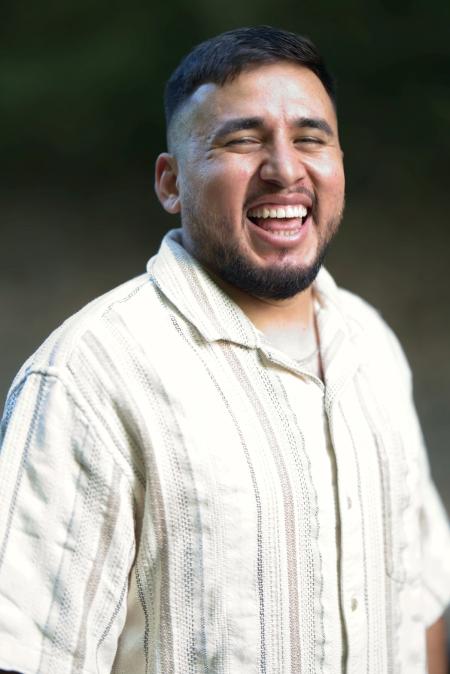 Portrait of a laughing man in a cream striped shirt